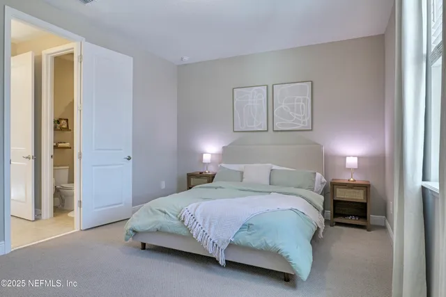 a bedroom with a bed and a night stand