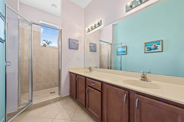 a spacious bedroom with a bed and a chandelier