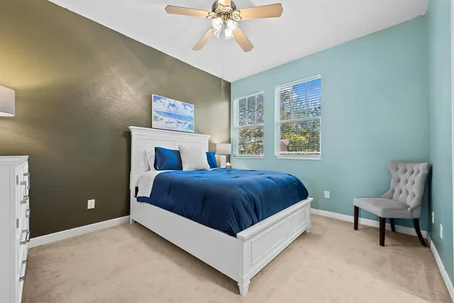a bedroom with a large bed and a chandelier