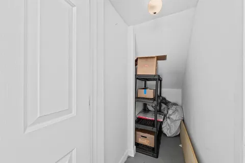 a view of swimming pool with a lawn chairs and palm trees