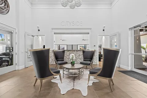 a view of a dining room and livingroom with furniture wooden floor and a rug