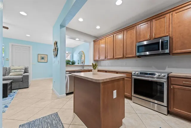a kitchen with a refrigerator sink and cabinets