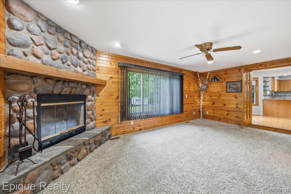 1221 Rhodes Road Lake Orion, MI 48360 - Photo 28 of 72 Stone-clad fireplace with a wood mantel and hearth