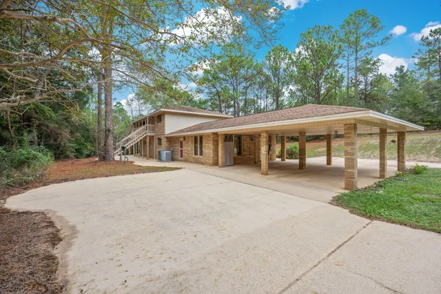 a view of a house with a yard and seating space