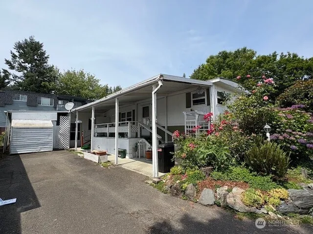 a front view of a house with a garden