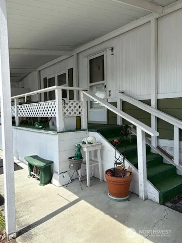 a living room with furniture a flat screen tv and kitchen view