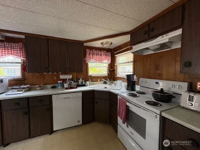 a kitchen with a sink a stove and cabinets