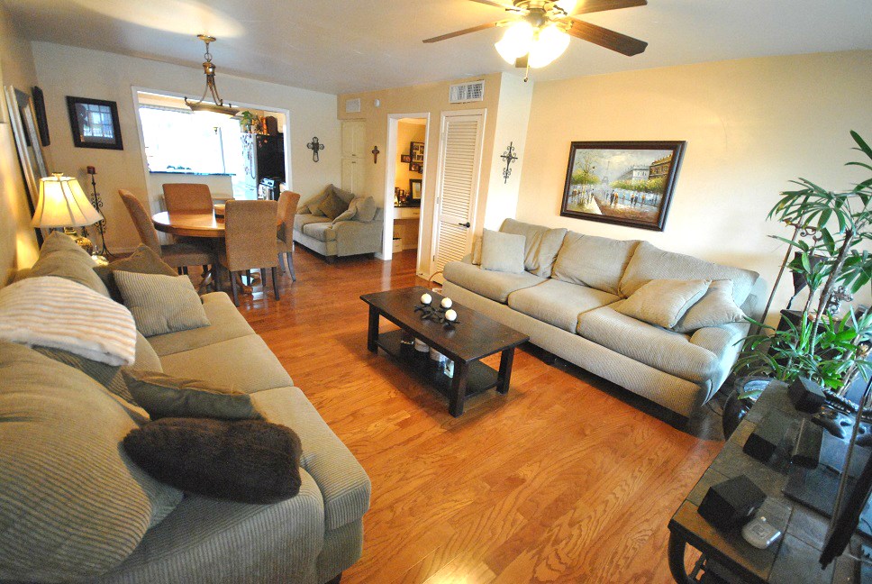 a living room with furniture a chandelier and a window