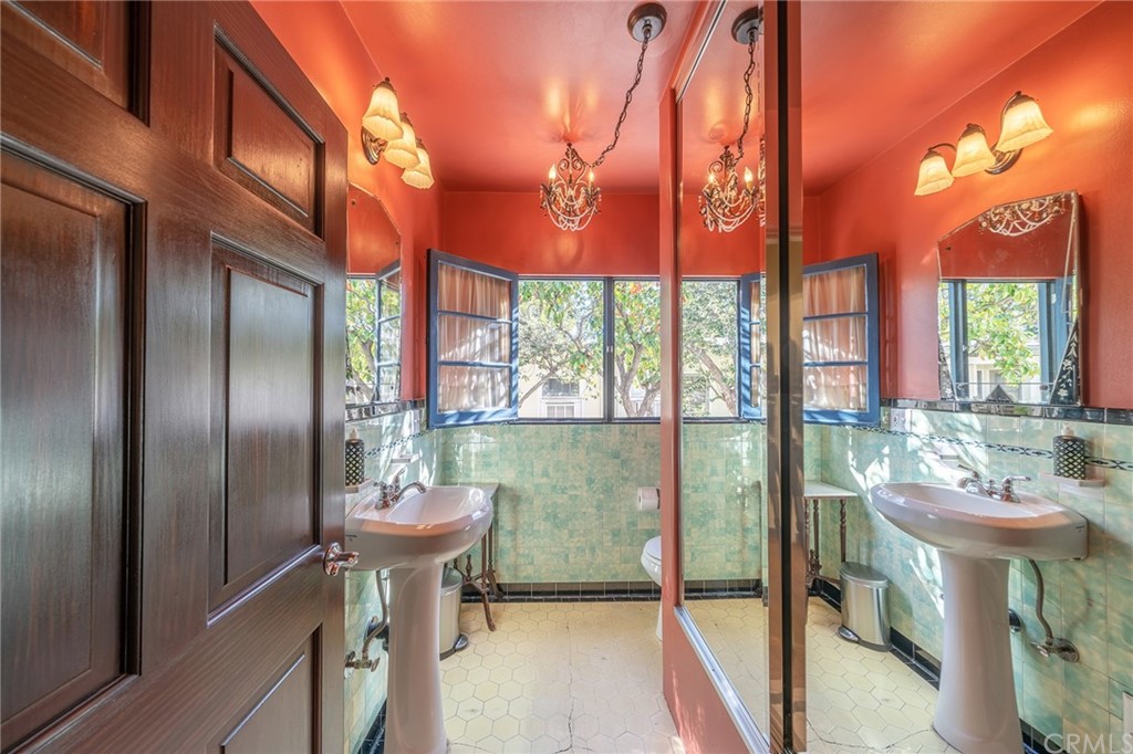 1853 Allen Avenue Pasadena, CA 91104 - Photo 16 of 38 a bathroom with a sink a mirror and a shower