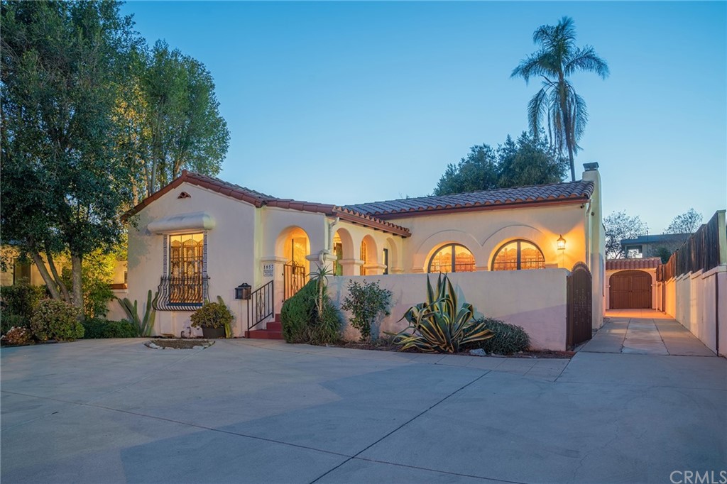 1853 Allen Avenue Pasadena, CA 91104 - Photo 2 of 38 a view of a brick house with a clock on the side