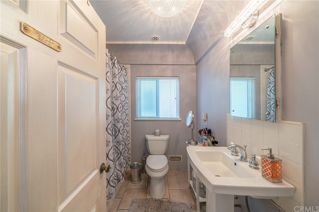 1853 Allen Avenue Pasadena, CA 91104 - Photo 24 of 38 a bathroom with a sink a toilet and shower curtain