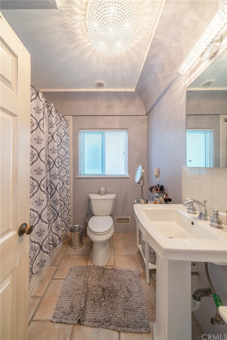 1853 Allen Avenue Pasadena, CA 91104 - Photo 25 of 38 a bathroom with a sink a toilet and shower