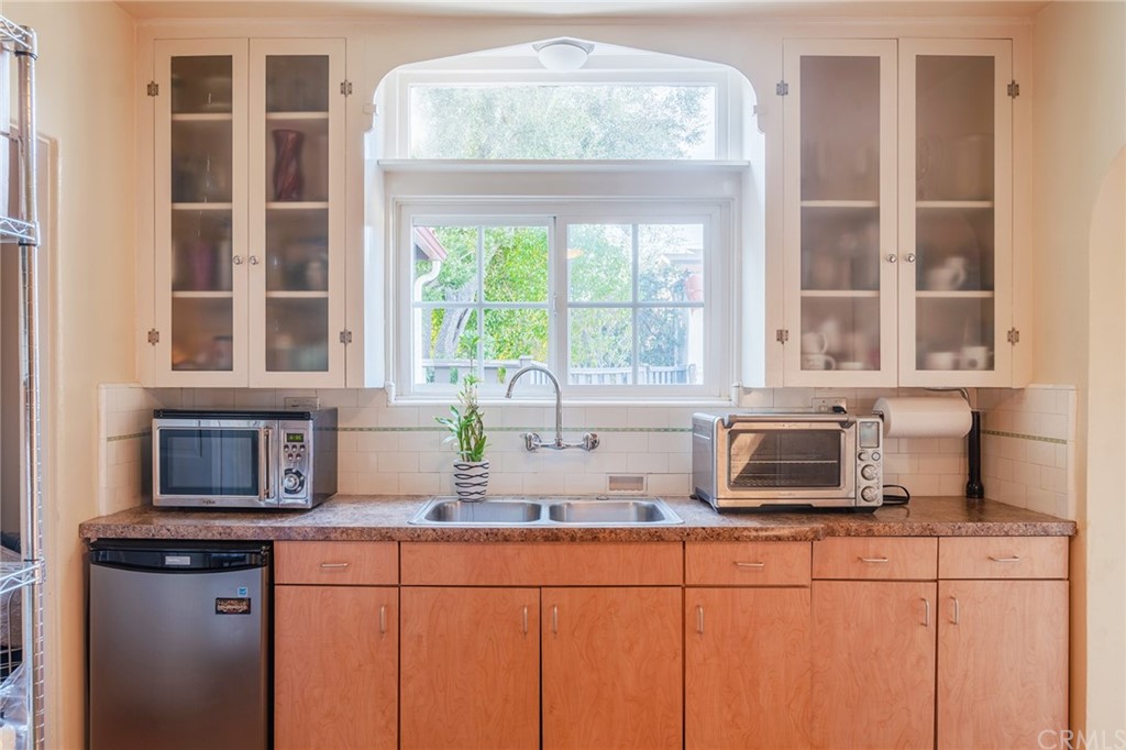 1853 Allen Avenue Pasadena, CA 91104 - Photo 9 of 38 a kitchen with stainless steel appliances granite countertop a sink a window and cabinets