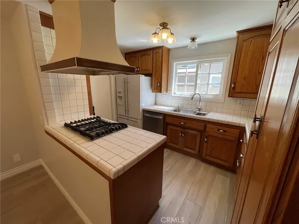 a kitchen with a stove a sink and a refrigerator
