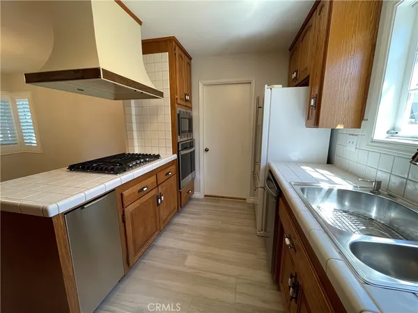 a kitchen with a sink stove and refrigerator