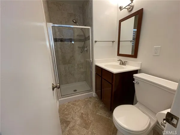 a white toilet sitting next to a bathroom sink