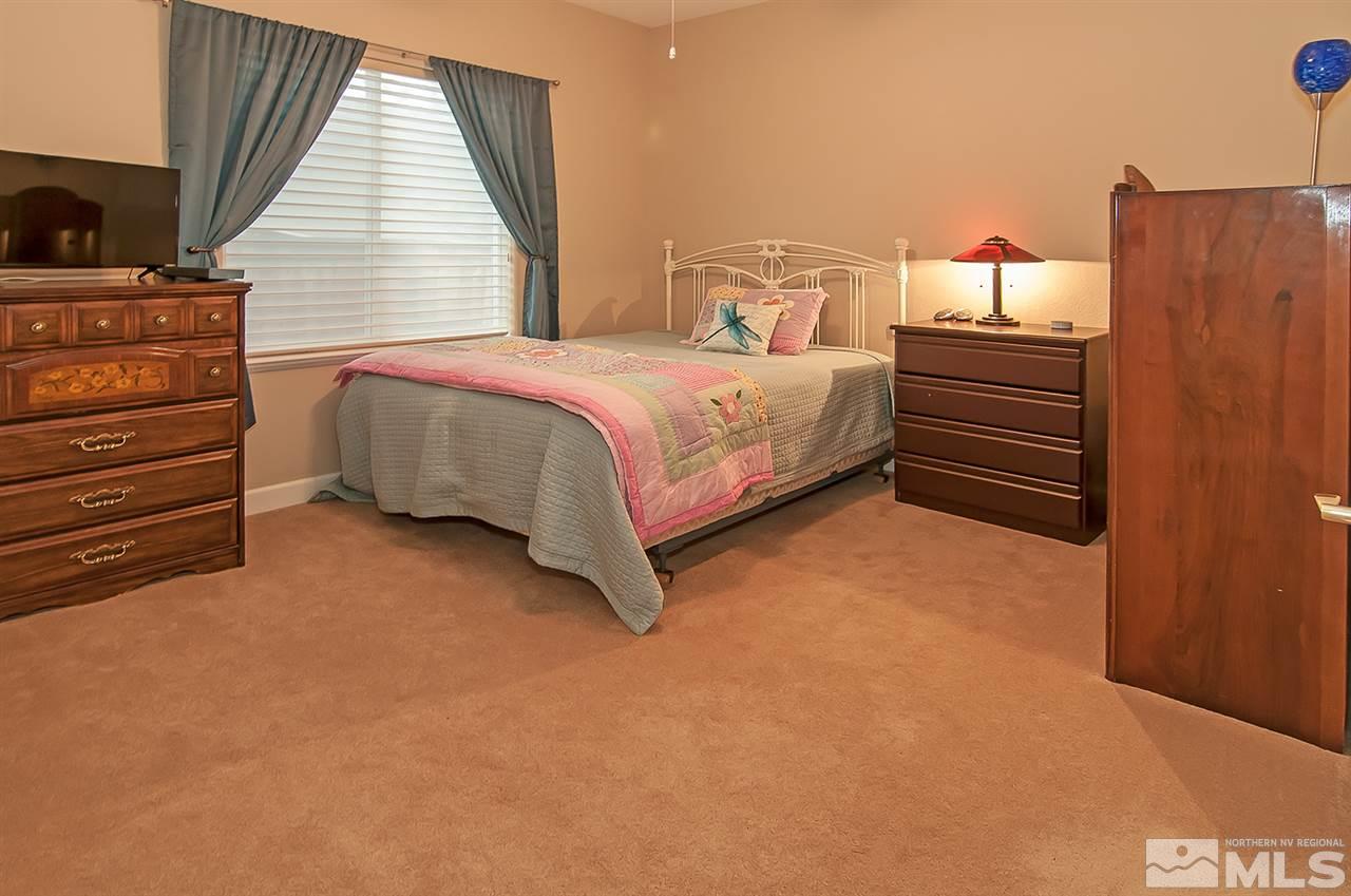 2690 Strathmore Court Reno, NV 89521 - Photo 18 of 25 a bedroom with a bed and dresser