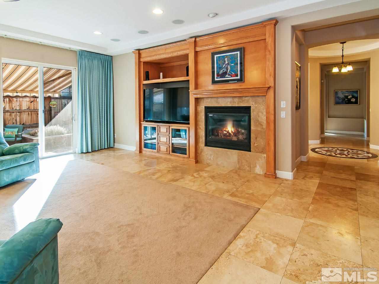 2690 Strathmore Court Reno, NV 89521 - Photo 3 of 25 a view of livingroom with fireplace and window