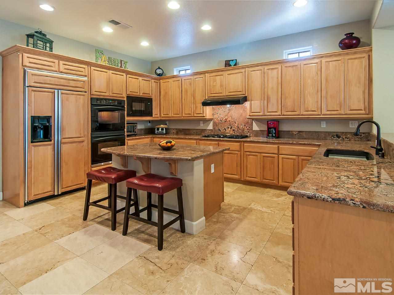 2690 Strathmore Court Reno, NV 89521 - Photo 5 of 25 a kitchen with stainless steel appliances granite countertop a sink and a refrigerator
