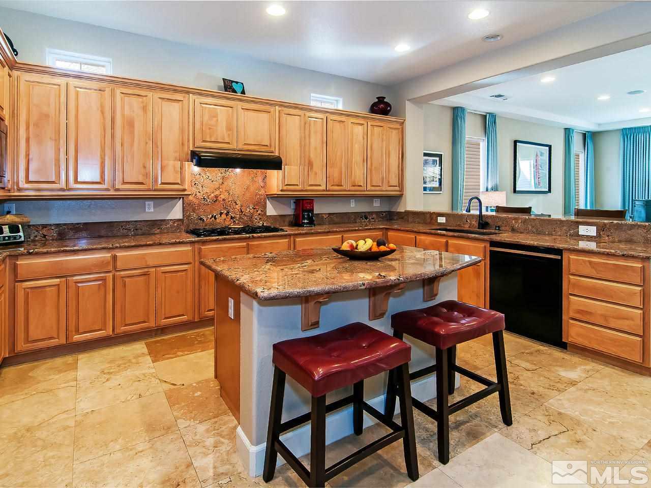 2690 Strathmore Court Reno, NV 89521 - Photo 6 of 25 a kitchen with granite countertop a stove a sink dishwasher and cabinets with wooden floor