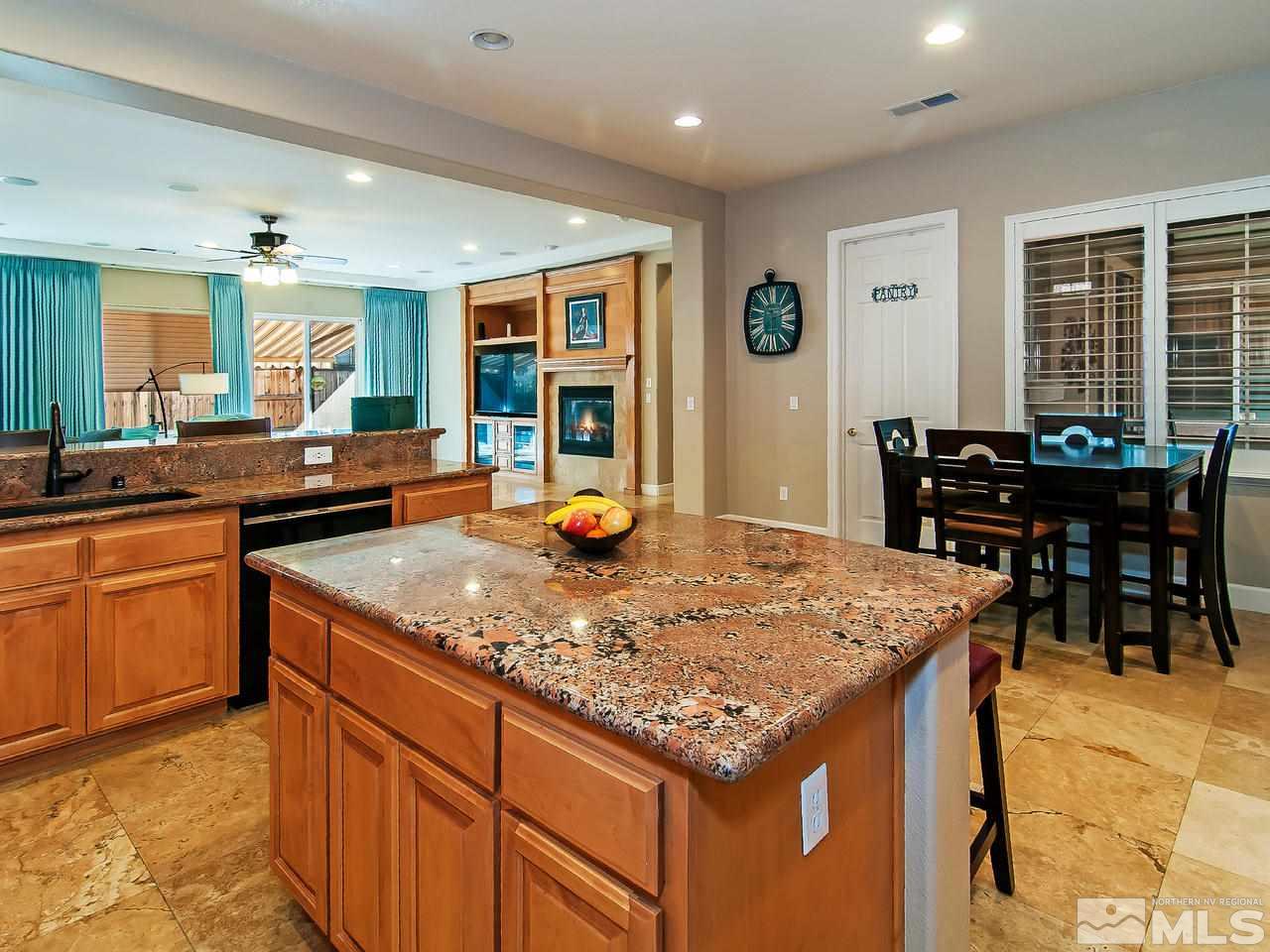 2690 Strathmore Court Reno, NV 89521 - Photo 8 of 25 a kitchen with stainless steel appliances granite countertop sink stove dining table and chairs