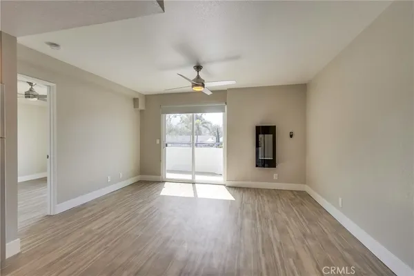 a large kitchen with cabinets wooden floor and stainless steel appliances