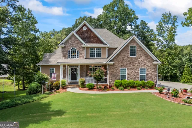 a front view of a house with a yard and potted plants