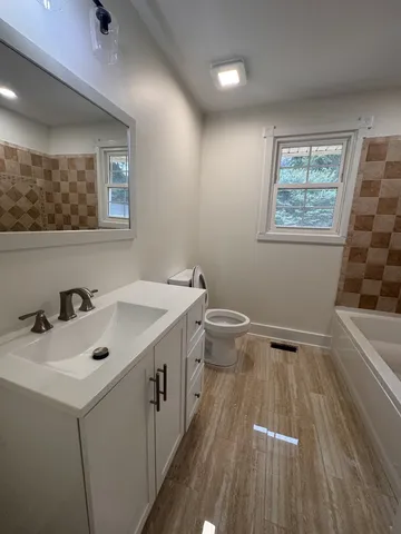 a bathroom with a sink mirror and window
