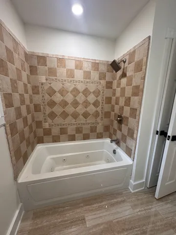 a bathroom with a bathtub and a shower