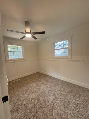 an empty room with a empty space and windows