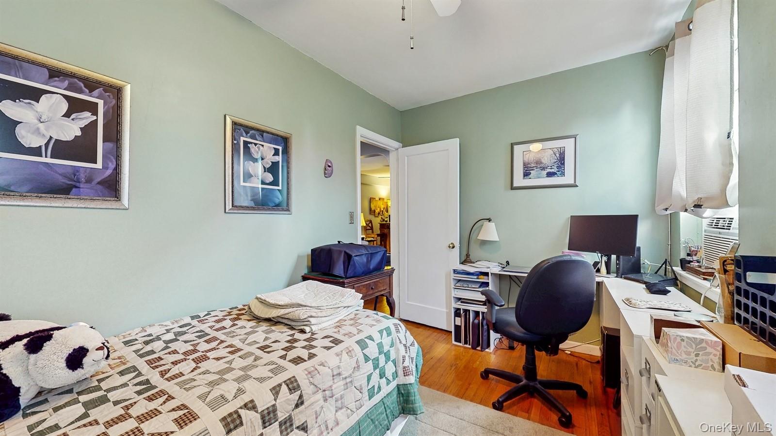 755 Bronx River Road, Unit 6C Bronxville, NY 10708 - Photo 15 of 22 a bedroom with a bed and wooden floor