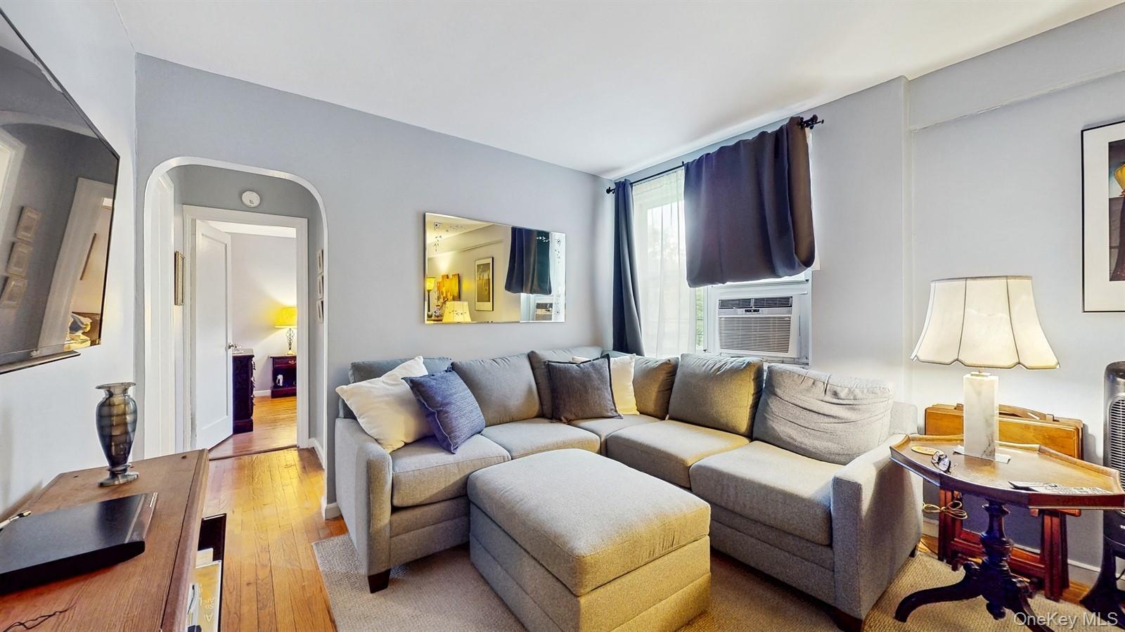755 Bronx River Road, Unit 6C Bronxville, NY 10708 - Photo 6 of 22 a living room with furniture and a flat screen tv