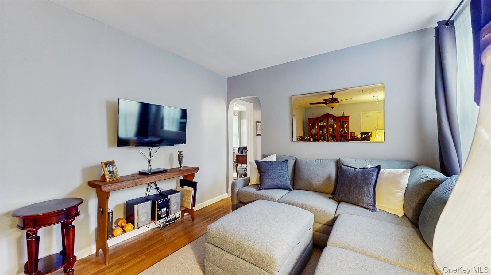 755 Bronx River Road, Unit 6C Bronxville, NY 10708 - Photo 7 of 22 a living room with furniture and a flat screen tv