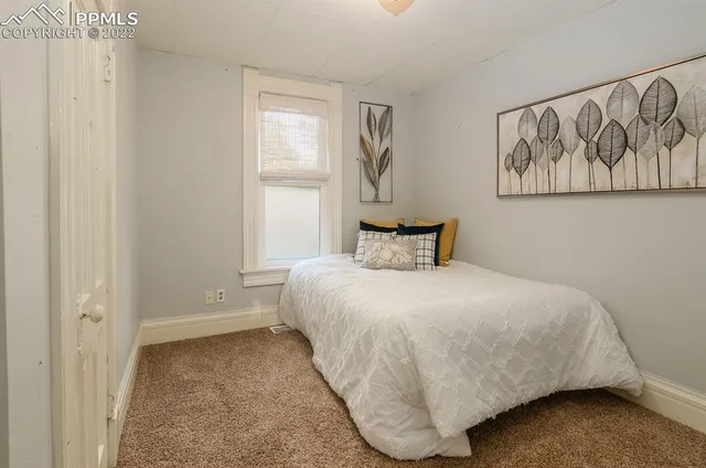 a bedroom with a bed and window