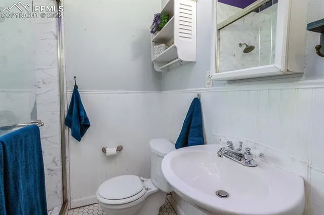 a bathroom with a toilet and a shower curtain