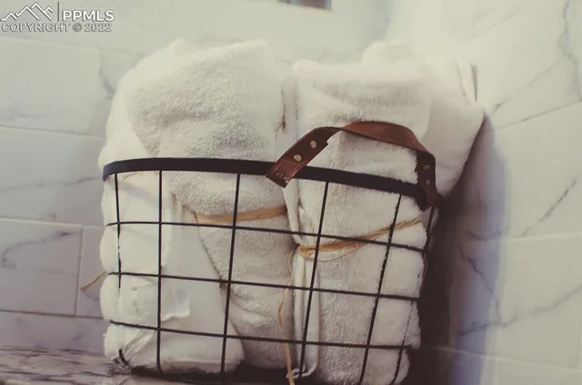 a backyard of a house with plants and wooden fence