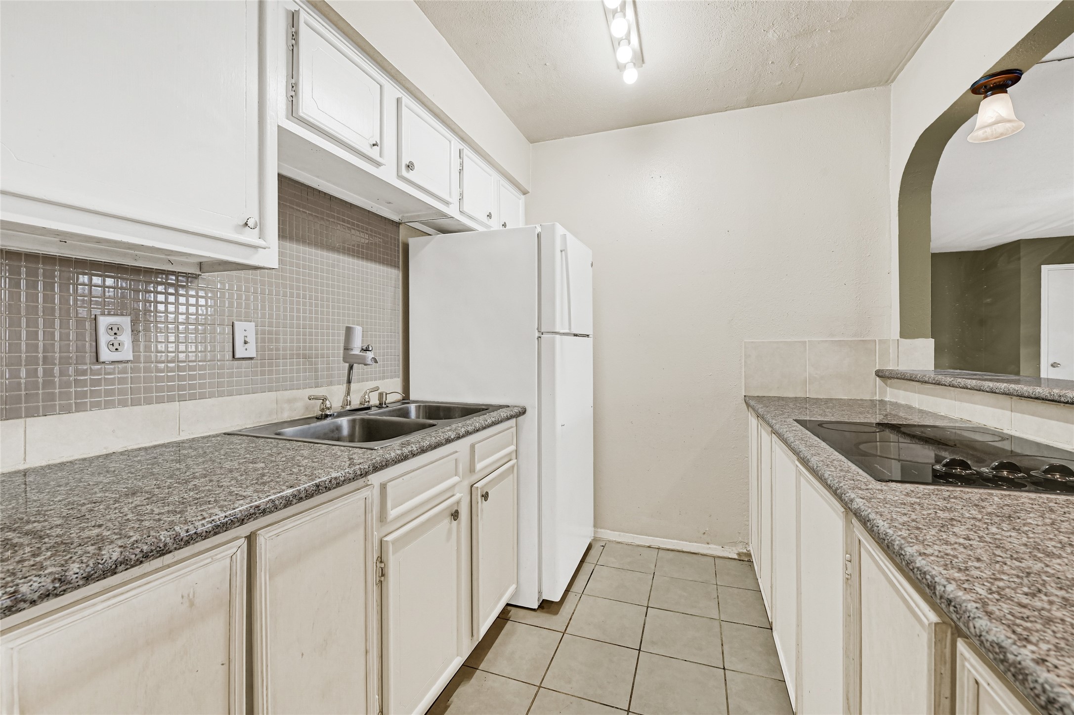 11550 Chimney Rock Road, Unit 232 Houston, TX 77035 - Photo 11 of 30 a kitchen with granite countertop a sink and cabinets