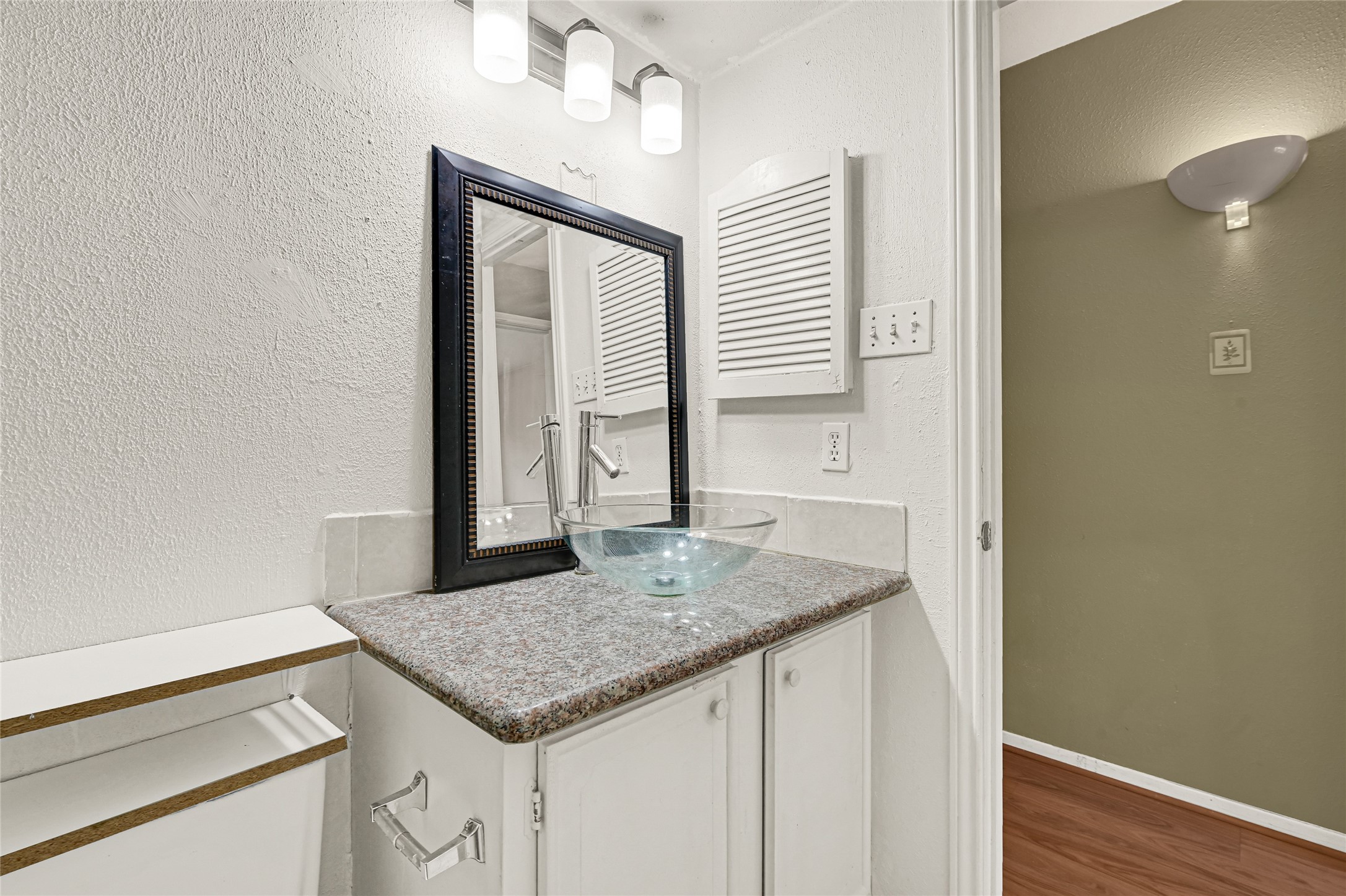 11550 Chimney Rock Road, Unit 232 Houston, TX 77035 - Photo 14 of 30 a kitchen with granite countertop a sink and a wooden floor