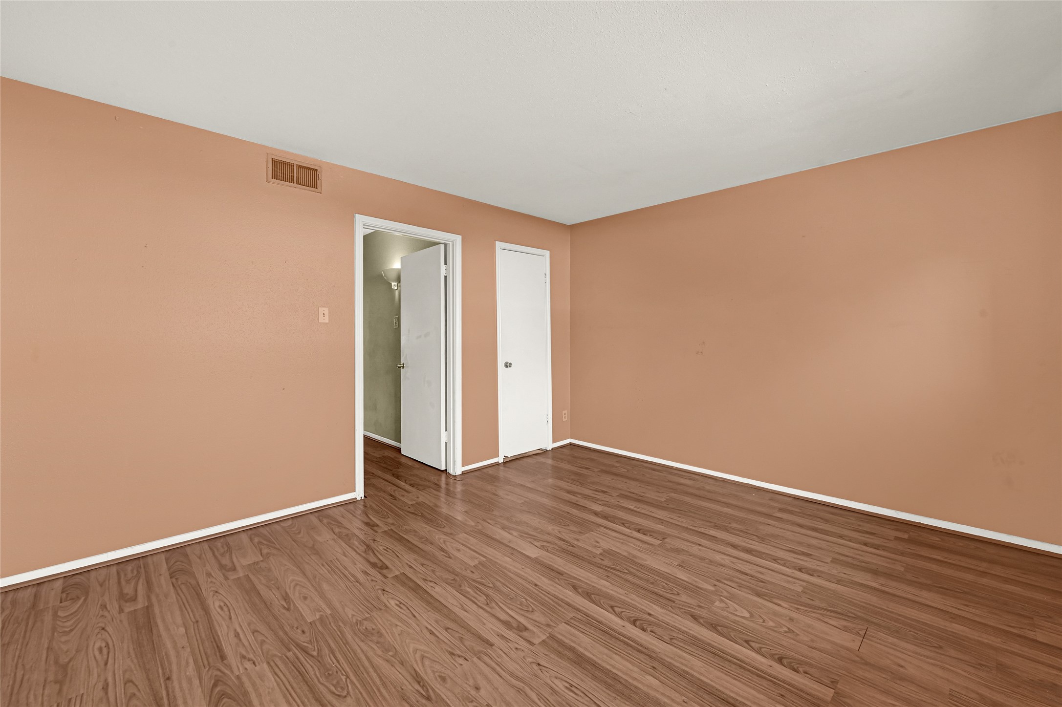 11550 Chimney Rock Road, Unit 232 Houston, TX 77035 - Photo 19 of 30 a view of an empty room with wooden floor and a window