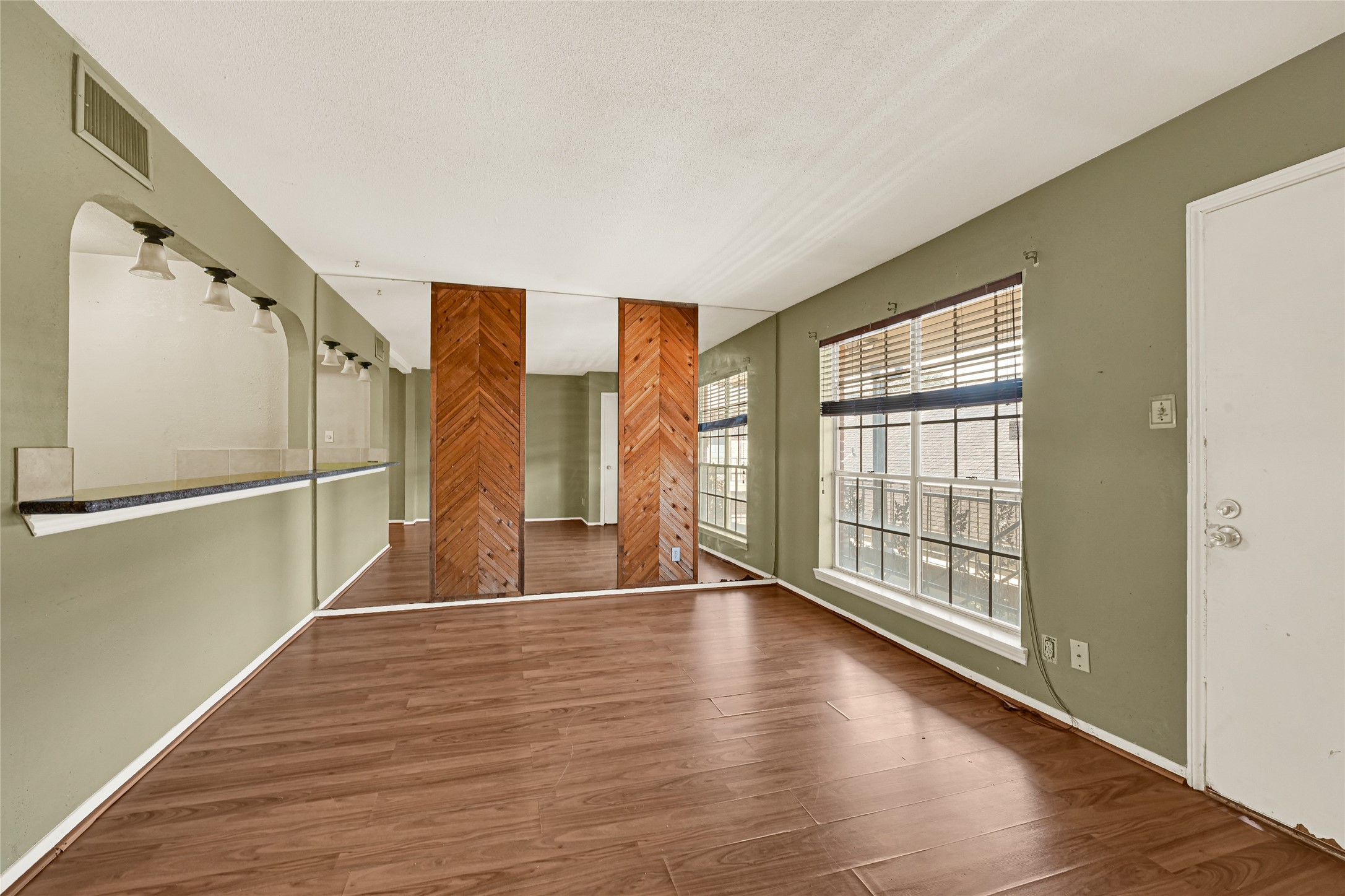 11550 Chimney Rock Road, Unit 232 Houston, TX 77035 - Photo 5 of 30 wooden floor in an empty room with a window