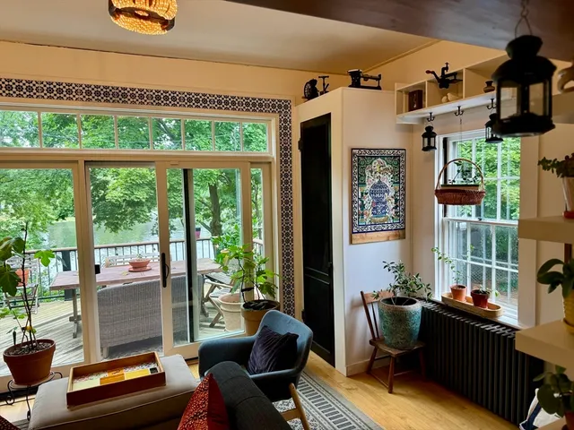 a living room with furniture and a floor to ceiling window