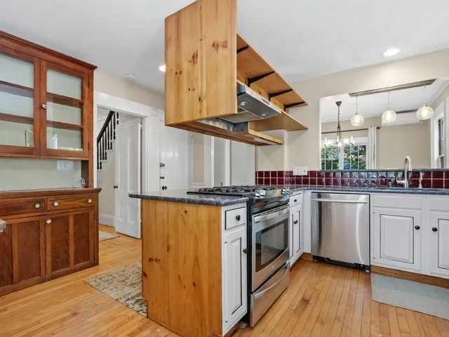 a kitchen with stainless steel appliances granite countertop a stove and a sink