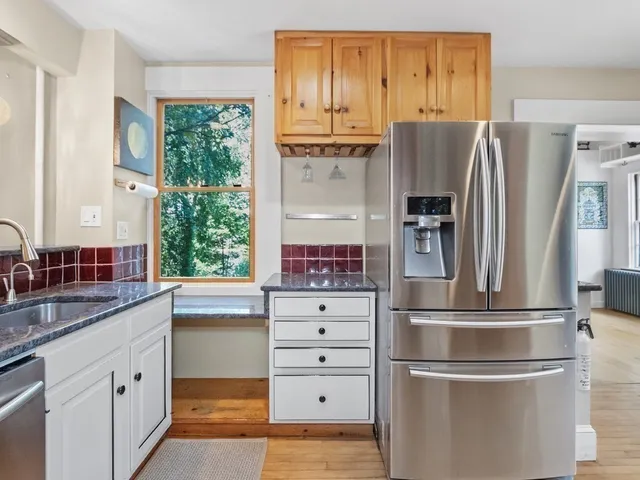a kitchen with stainless steel appliances granite countertop a refrigerator and a sink
