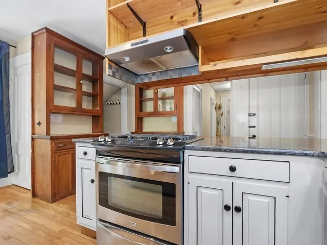 a kitchen with stainless steel appliances granite countertop a stove and a microwave