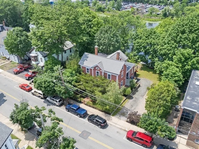 an aerial view of a house with a yard