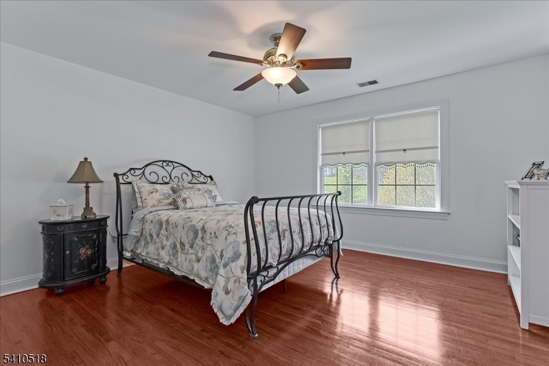 1 Brodziak Road Denville, NJ 07834 - Photo 24 of 42 a bedroom with a bed and wooden floor