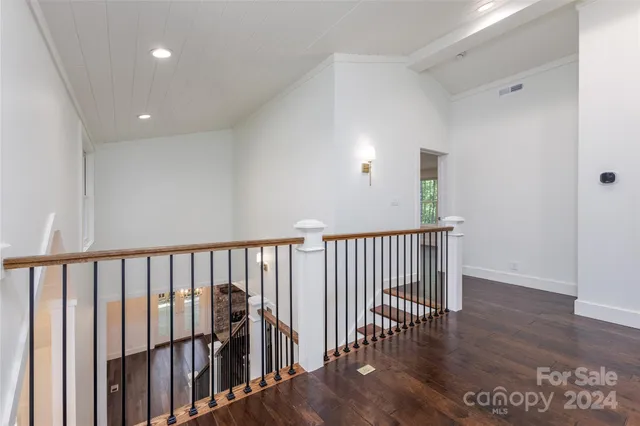 a view of hallway with wooden floor