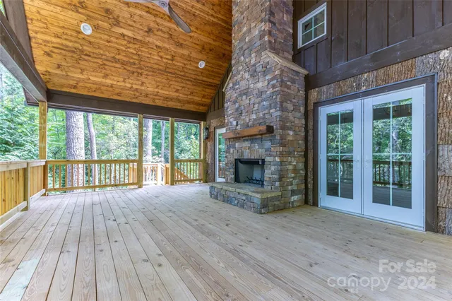 a view of empty room with wooden floor and fireplace