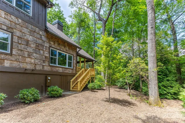 a view of house with a backyard