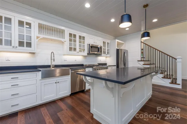 a kitchen with granite countertop a sink and stove